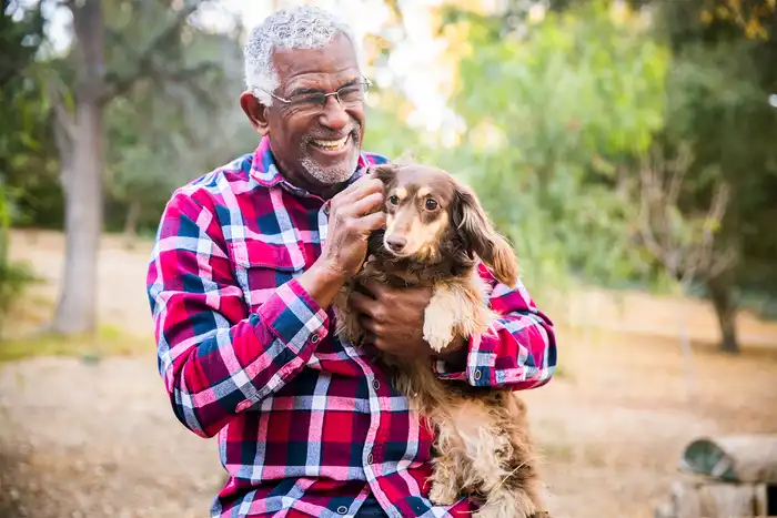 photo of man petting dog