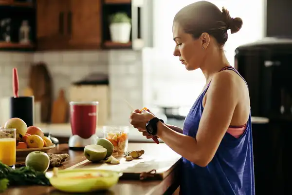photo of woman making smoothie