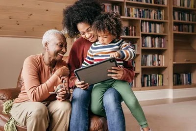 photo of three generation family with tablet