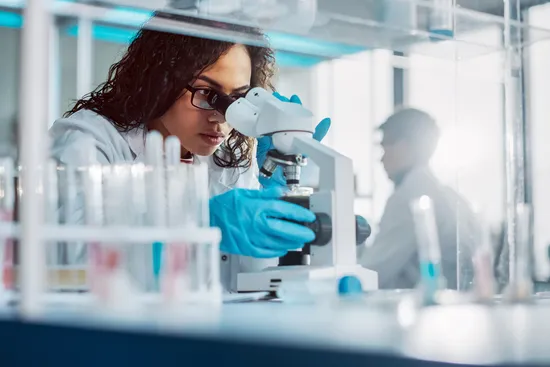photo of clinical researcher using microscope