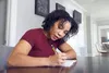 photo of woman taking notes