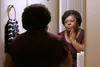 photo of woman looking in mirror