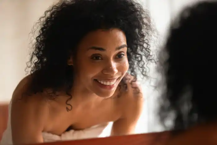 photo ofwoman looking in mirror