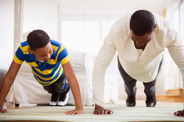 photo of father and son doing pushups
