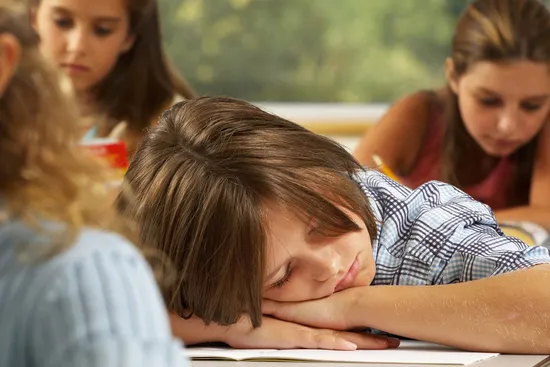 child asleep in classroom