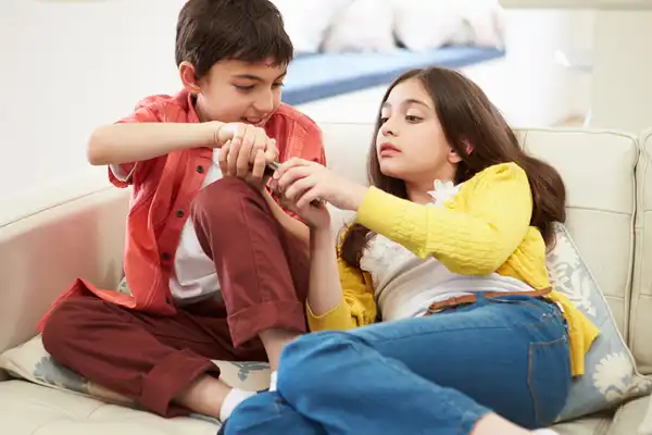 photo of brother and sister arguing over tv remote