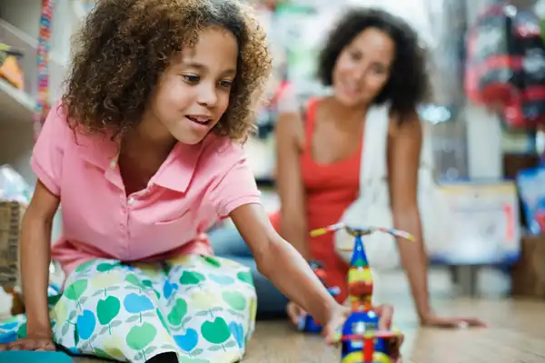 photo of child playing with toy
