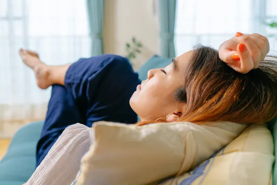 photo of woman taking nap on sofa